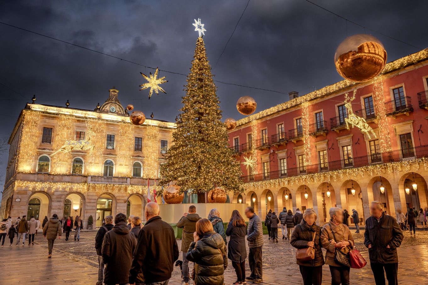 square decorated with christmas lights on buildins around on the christmas tree