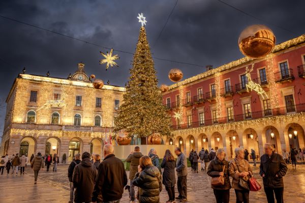 square decorated with christmas lights on buildins around on the christmas tree
