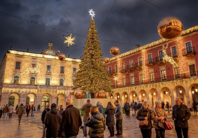 square decorated with christmas lights on buildins around on the christmas tree