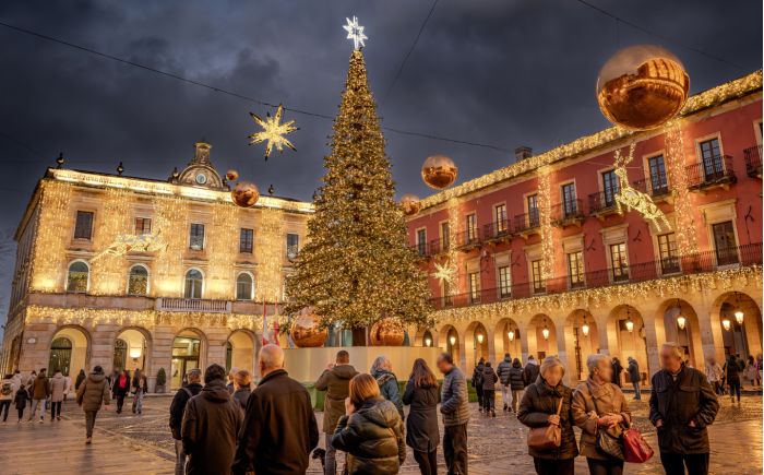 square decorated with christmas lights on buildings around on the christmas tree