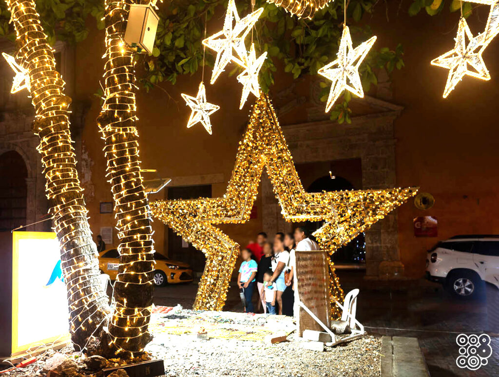 big lighting star with inside people that take pictures and small hanging lighting stars