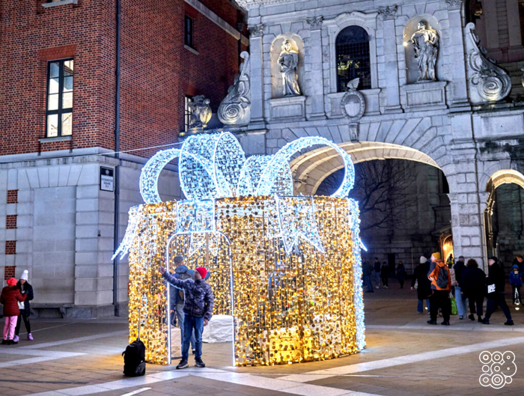 a boy taking selfies with a giant lighting gift box
